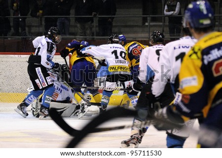 ZELL AM SEE; AUSTRIA - OCT 01: Austrian National League. A player of EKZ (blue jersey) gets crosschecked from behind. Game EK Zell am See vs Linz II (Result 5-2) on October 01, 2011 in Zell am See.