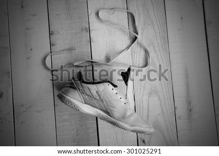 black and white tone of sport shoe and string on panel