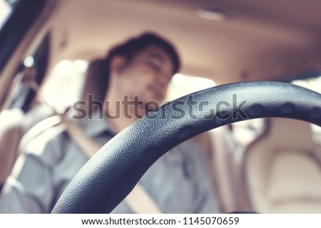Blur image,man be tired sleep in car