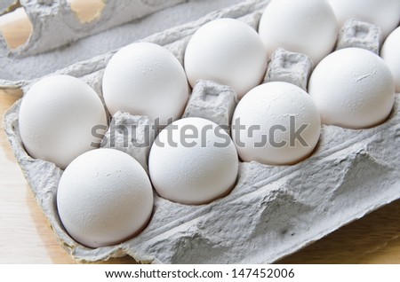 A dozen of white eggs in a box