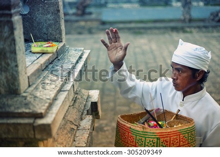 ULUWATU, BALI - CIRCA January 2011 - A temple priest gives offerings and prayers  before a traditional Fire Dance ceremony at the Uluwatu Temple. The ancient Hindu temple features ocean cliff views.