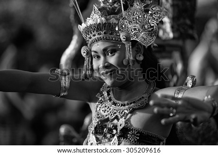 ULUWATU, BALI - CIRCA January 2011 - A woman dances during a traditional Kecak Fire Dance ceremony at the Uluwatu Temple. The ancient Hindu temple features ocean cliff views and wild monkeys.