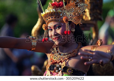 ULUWATU, BALI - CIRCA January 2011 - A woman dances during a traditional Kecak Fire Dance ceremony at the Uluwatu Temple. The ancient Hindu temple features ocean cliff views and wild monkeys.