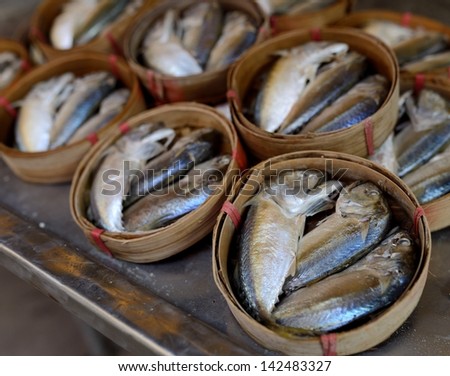 Cooked fish in barrels for sale at a market in Bangkok, Thailand.