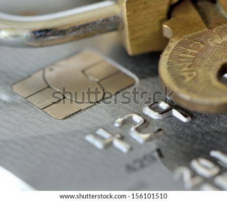 macro shot of an old credit card with pad lock and key