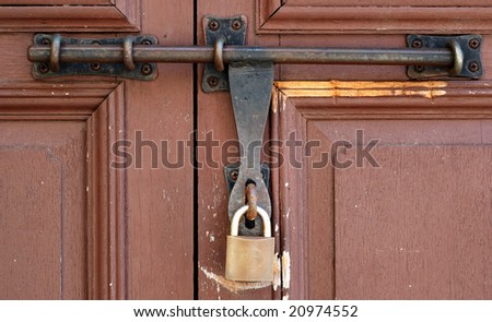 vintage wooden door with a pad lock