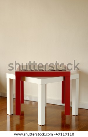two wooden tables in white and red