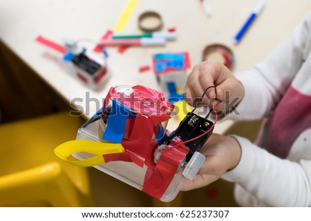 Construction of children\'s robots. Colored boxes with paper strips, inventions and creativity for children. Trash Robots, Tinkering and making, educational activities for schools and children