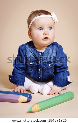 Funny toddler with big pencils