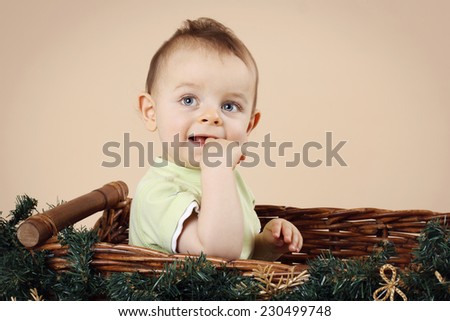 Little boy sitting in the christmas basket