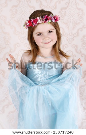 Little girl wearing princess dress and floral wreath