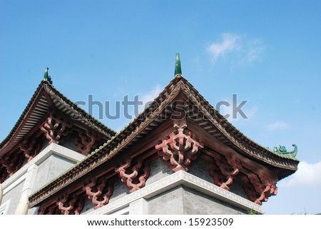 The double eaves with ceramic animal figurine and wood brackets on a Chinese ancient building.