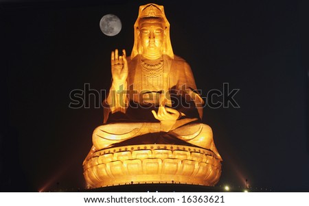 The great bronze statue of Bodhisattva in moonlight night,   illuminated by flood light,low angel.