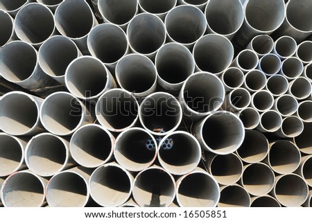 The round steel tubes of various size and caliber  pile background.
