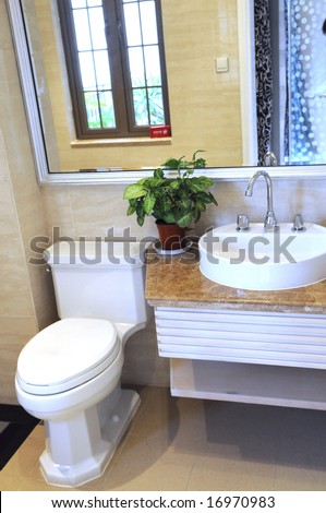 A modern family toilet with ceramic basin stand,and water closet.