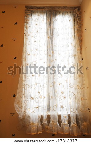 The soft and light voile curtain cloth with tassel in a family house room.