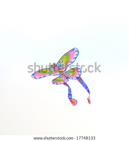 A colorful bird shaped paper kite flying in the sky.