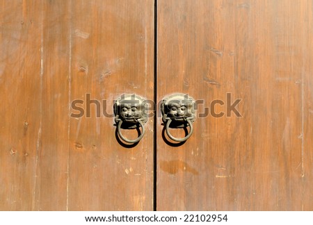 The Chinese wood door with bronze lion head and round knockers.