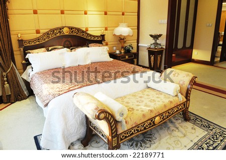 The cozy luxury family bedroom with classical fitments and furniture.