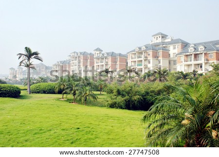 The villas with meadow and palm tree in a south China holiday resort.