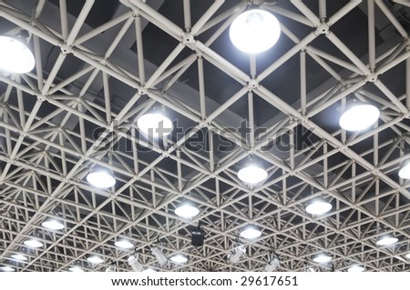 The ceiling steel beams with pendant lamps.