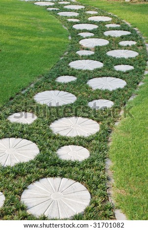 Garden Stepping Stones on The Curving Stepping Stone Path In The Garden Meadow  Stock Photo