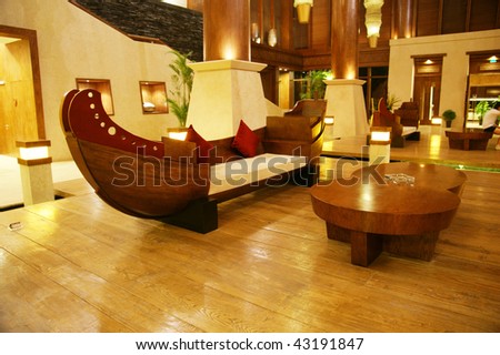 Modern luxury hotel lobby with wood upholstering and furniture.