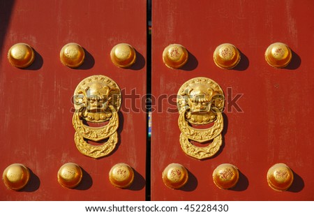 Red chinese door with a lion/dragon head ,imperial palace,Beijing. Concept: Chinese New Year celebration.