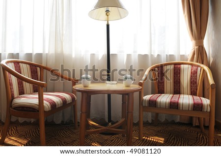 Two wood back rest chairs with cushion by the window,concept of intimate friends chatting.