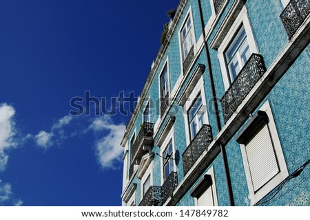The facades decorated with colored tiles of a typical house in Lisbon, Portugal.
