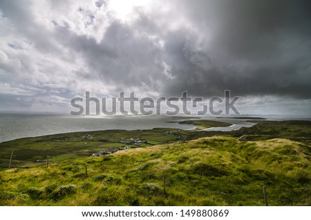 beautiful landscape with the green fields, the sea and clouds in Connemara, Ireland