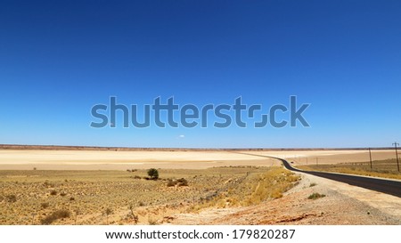 Road through arid landscape, Kalahari, South Africa