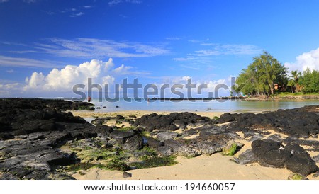 Rocky peninsula sticking out on calm ocean, Mauritius
