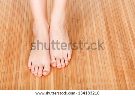 Female feet on a wooden floor