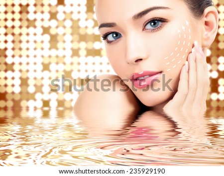 Young female with clean fresh skin, abstract background with blurred lights