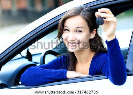 Cute girl shows a car key