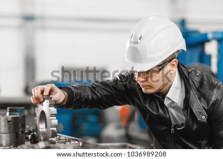 factory engineer checks the quality of the manufactured part