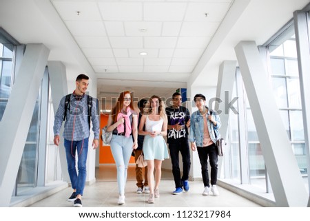 A group of young students from different countries go to classes. The photo illustrates education, College, school, or University.