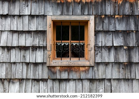 Wooden window in the wooden old roof