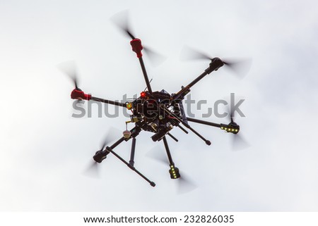 The small dron hexcopter flying over the field