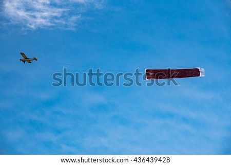 Large view on the small plane with advertising banner