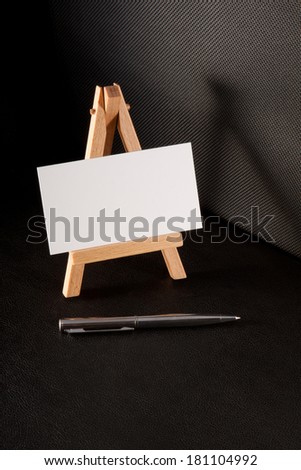 pen and blank business card on a wooden souvenir stand
