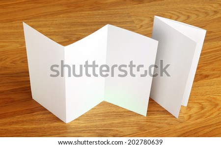 Blank folding page booklet on wooden background