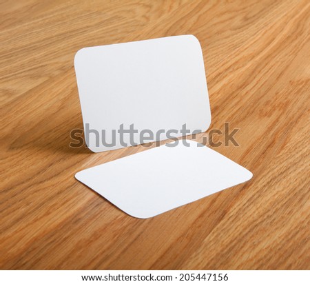 identity design, corporate templates, company style, blank business cards with rounded corners on a wooden background