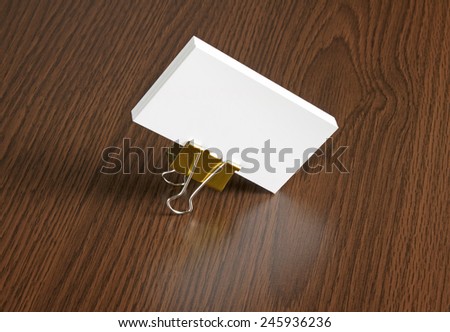 identity design, corporate templates, company style, blank business cards with clip on a wooden background