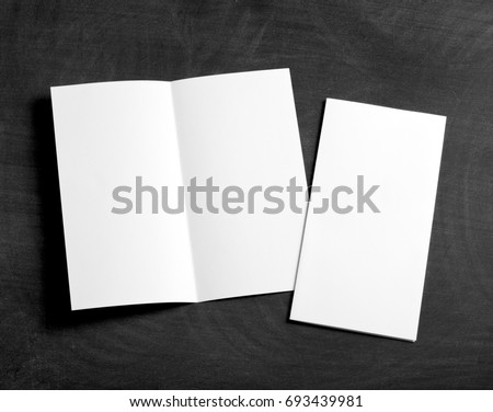 Identity design, corporate templates, company style, set of booklets, blank white folding paper flyer on a black chalkboard