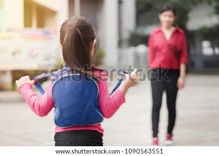 Back to school concept,Asian mother or parent taking daughter to school, asian girl carrying backpack prepare go to kindergarten in morning time, Selective focus