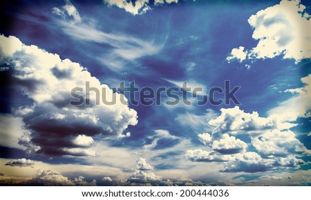 White fluffy clouds over blue sky, filtered image instagram effect
