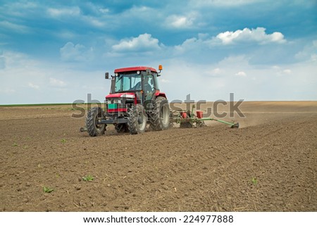 Farmer sowing corn maize crops
