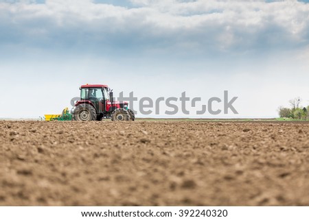 Farmer seeding, sowing crops at field
